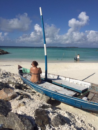 Girl on boat facing the sea in Maafushi Island Maldives