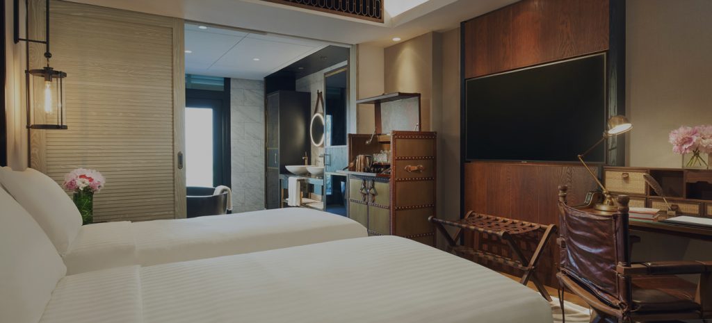 best luxury resorts in singapore barracks sentosa room interior twin bed wooden deco