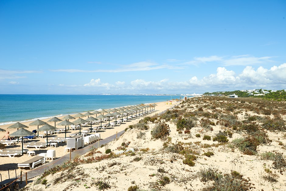 top 5 best beach getaways for summer around the world praia do ancao portugal beach umbrellas