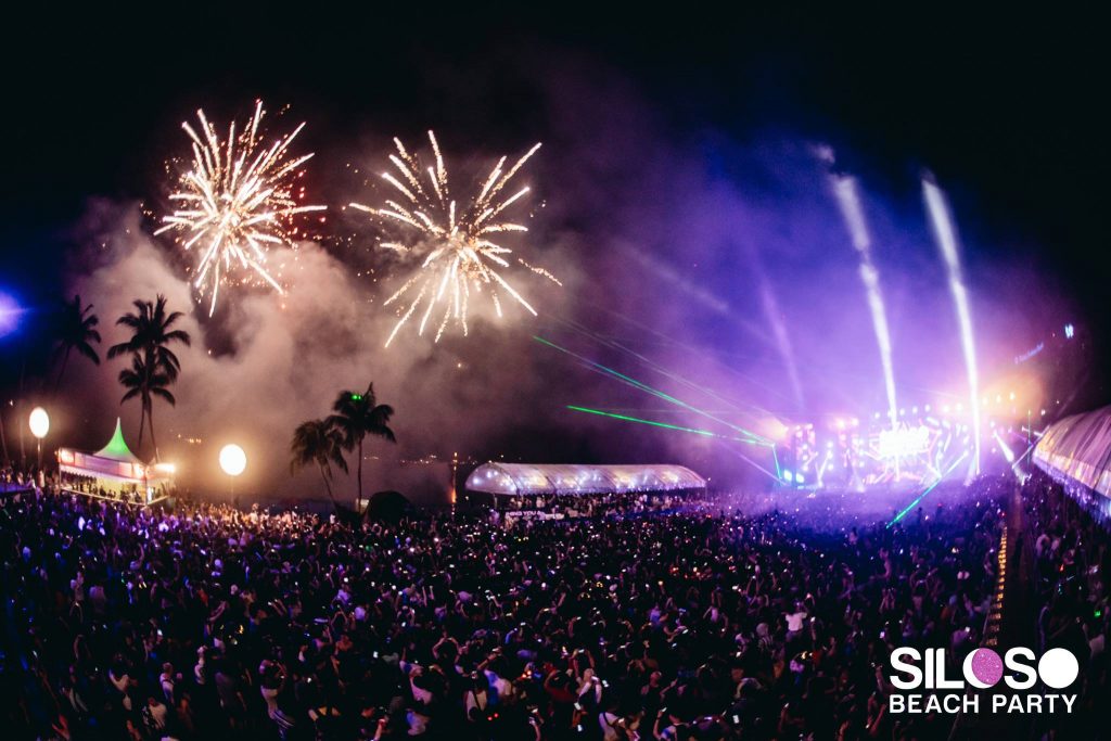 fireworks and crowd at Siloso beach party in sentosa singapore with light show and main stage
