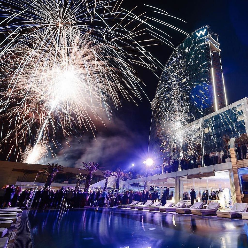 large firework display by the poolside of W Barcelona hotel by the beach