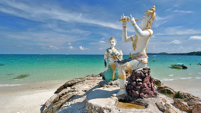 statues atop a rock in koh samet thailand