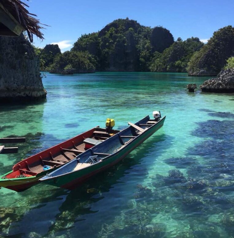 different colours of the sea - sampan in raja ampat, indonesia
