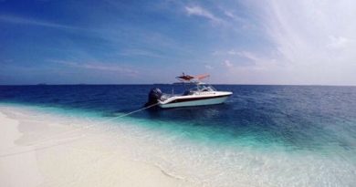 speedboat in clear water white sand beach