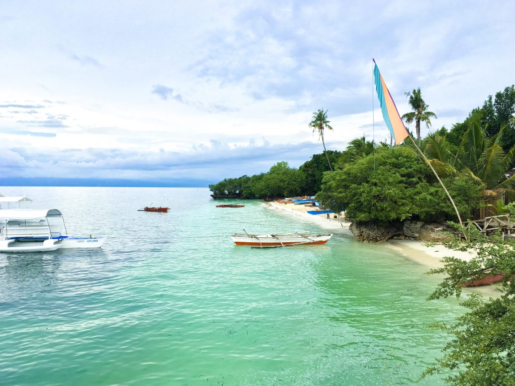 best things to see and do in siquijor island - paliton beach with fishermen boats
