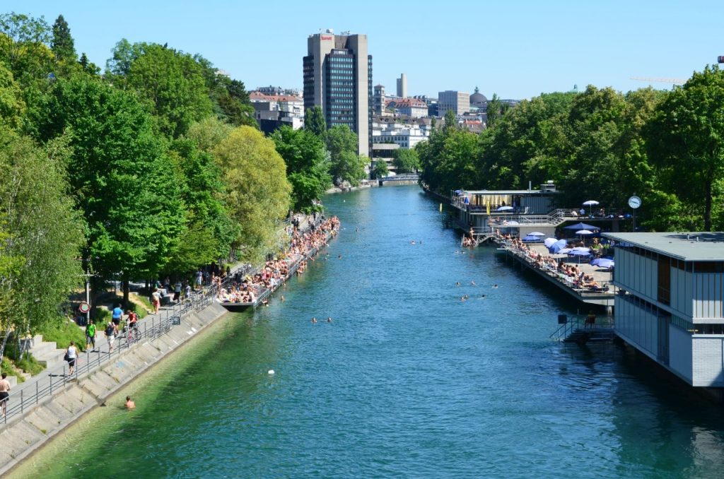 View of Oberer Letten Canal in Limmat River with Zurich city in the background-best rivers in switzerland safe for swimming