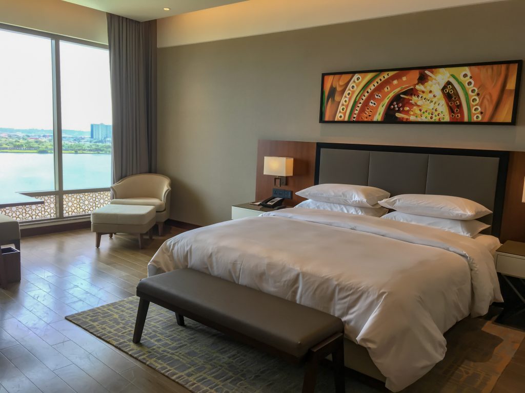 king bed inside the grand room with view of kochi 