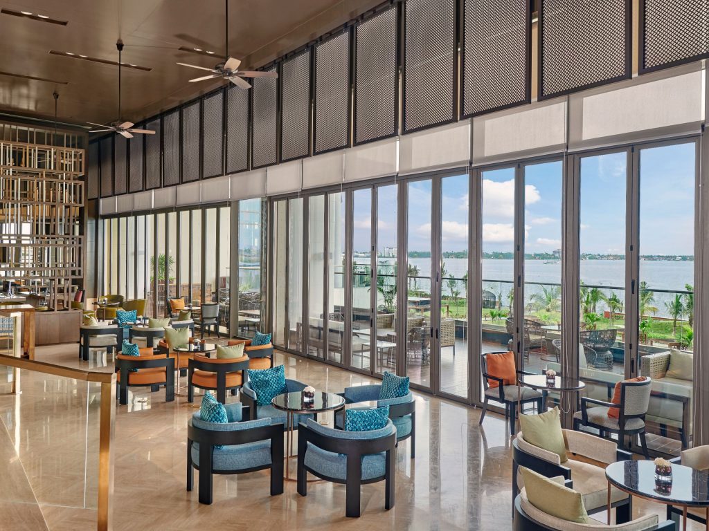 colourful chairs and a view of the lake from the lobby lounge