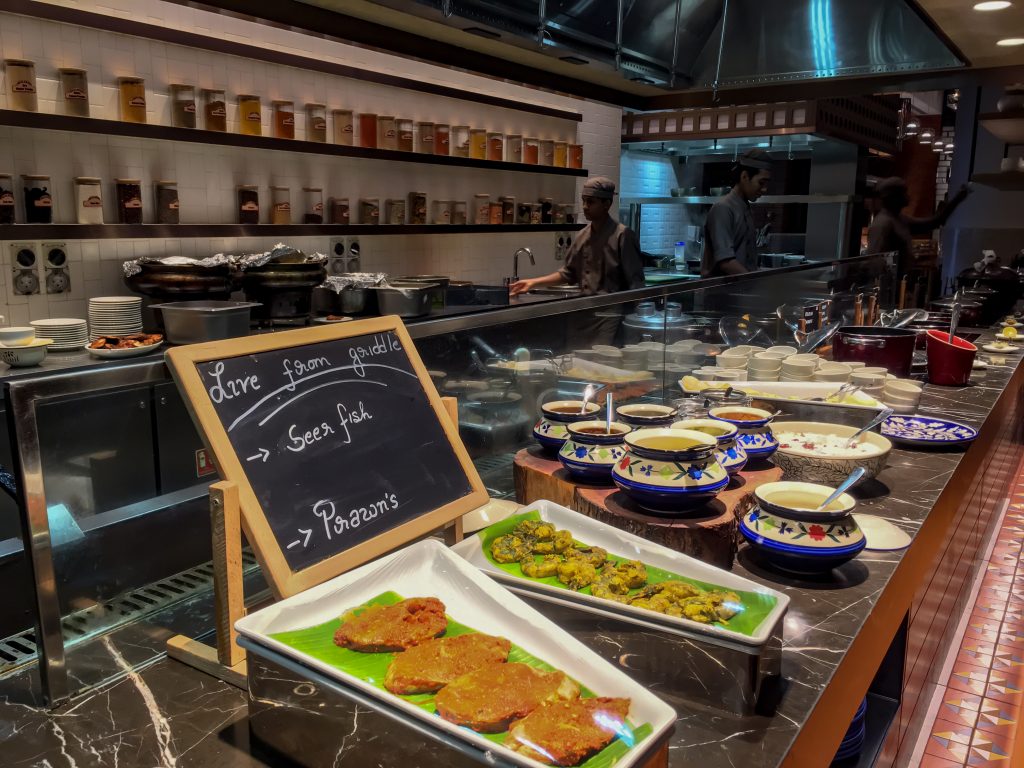 open concept kitchen at malabar cafe with buffet line of local curries