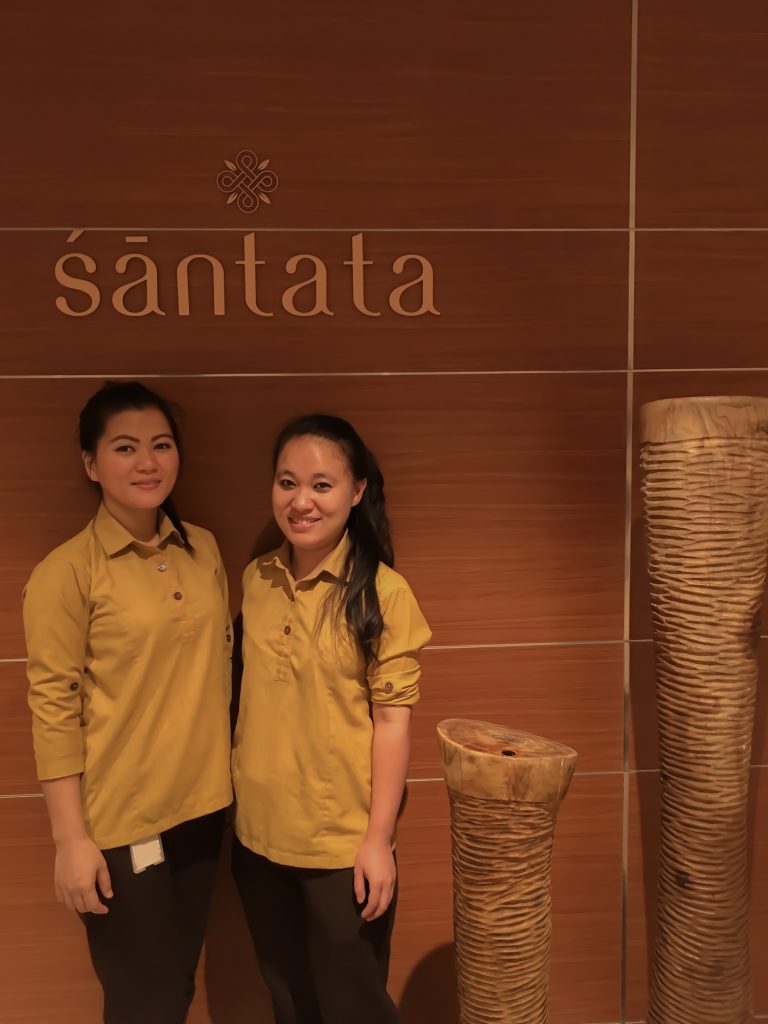 two spa therapist ladies smiling under the sign of Santata Spa