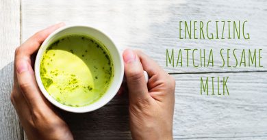 hands holding cup of matcha sesame milk