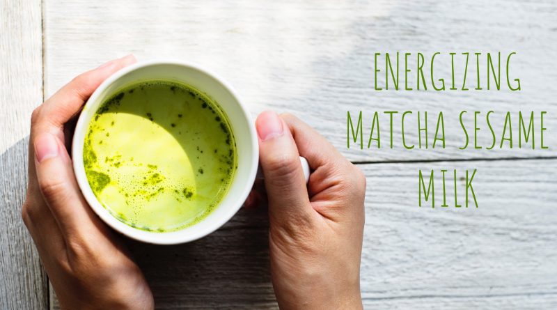 hands holding cup of matcha sesame milk