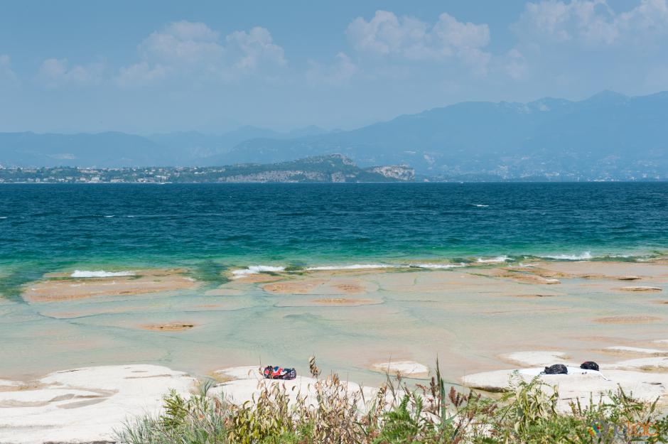 jamaica beach in sirmione with flat white rocks