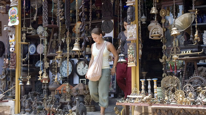 girl coming out of a curio antiques shop in Jew Town Mattancherry Kochi