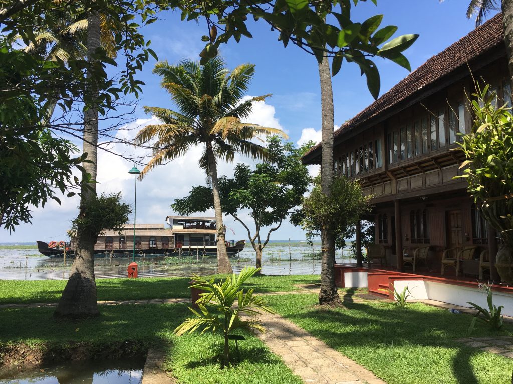 coconut lagoon resort heritage rooms with houseboat in Lake Vembanad in the background