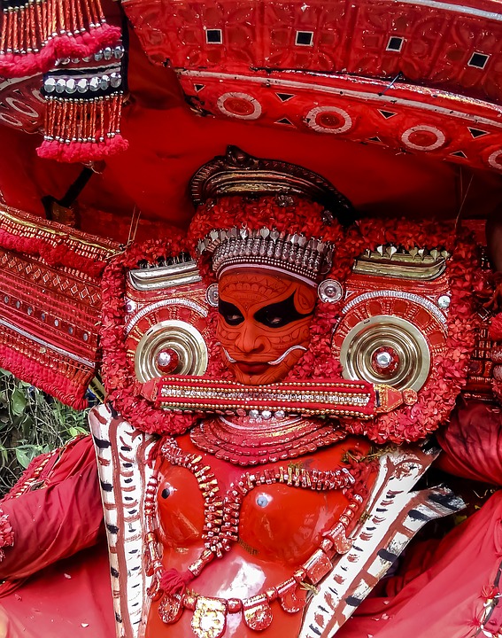 Theyyam performance full costume in red makeup