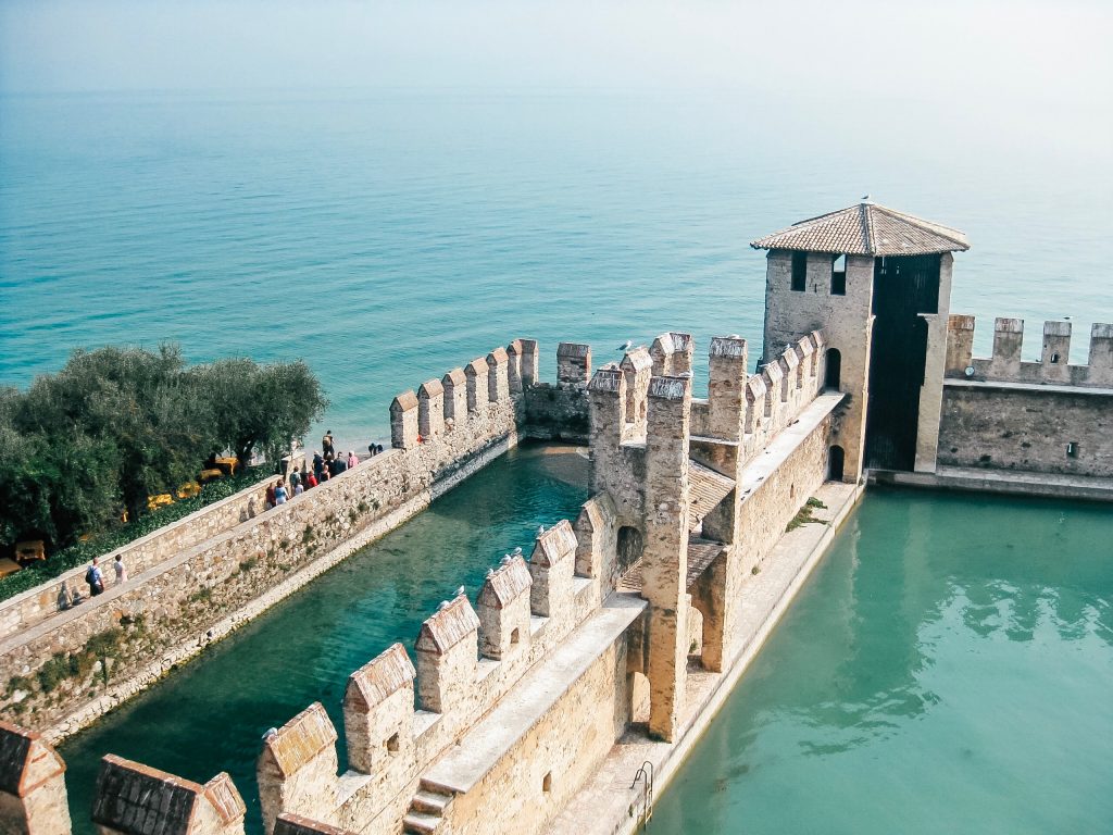 ariel view of scaliger castle in sirmione surrounded by water