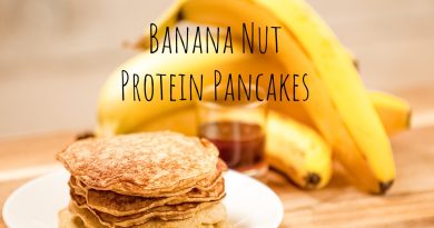 stack of pancakes on white plate with bananas in the background