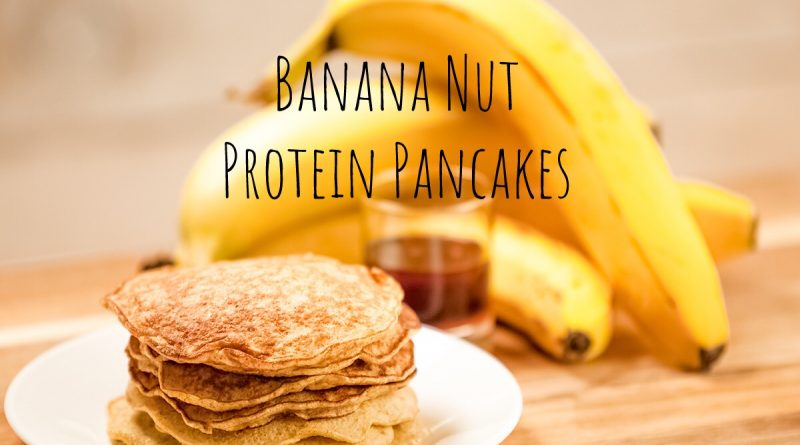 stack of pancakes on white plate with bananas in the background