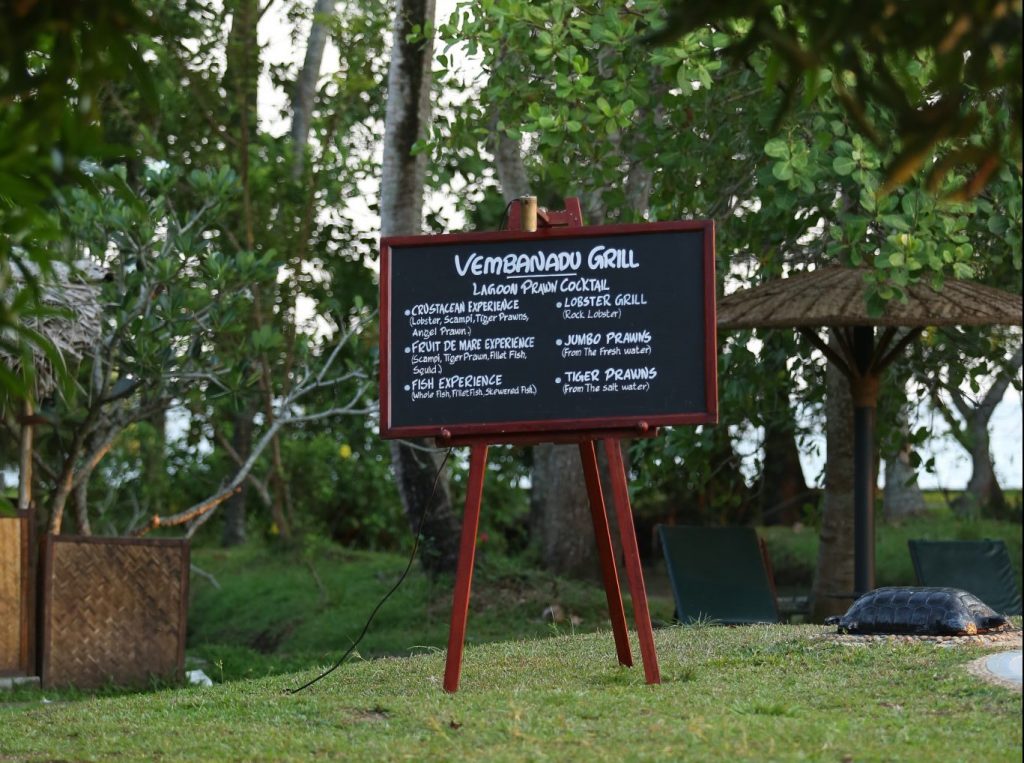 chalkboard menu for dinner surrounded by trees