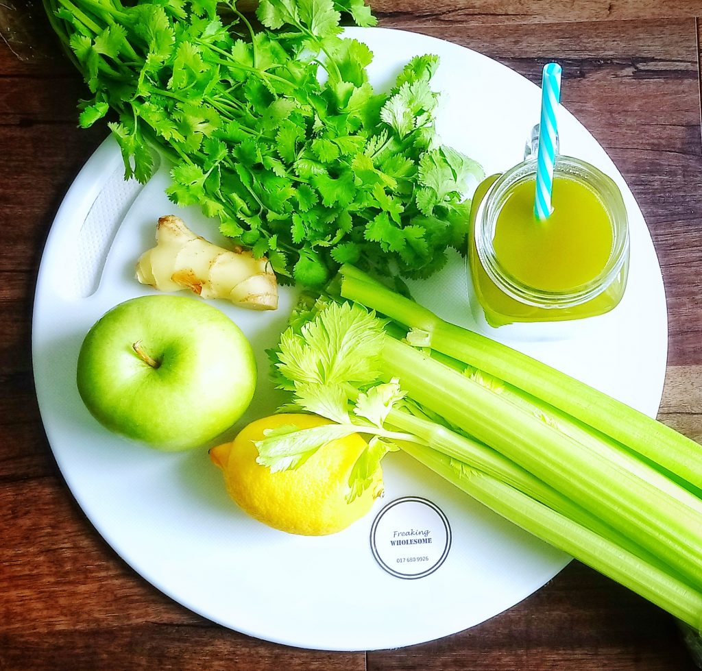 plate of celery, coriander, green apple, ginger and lemon with alkalising aid juice