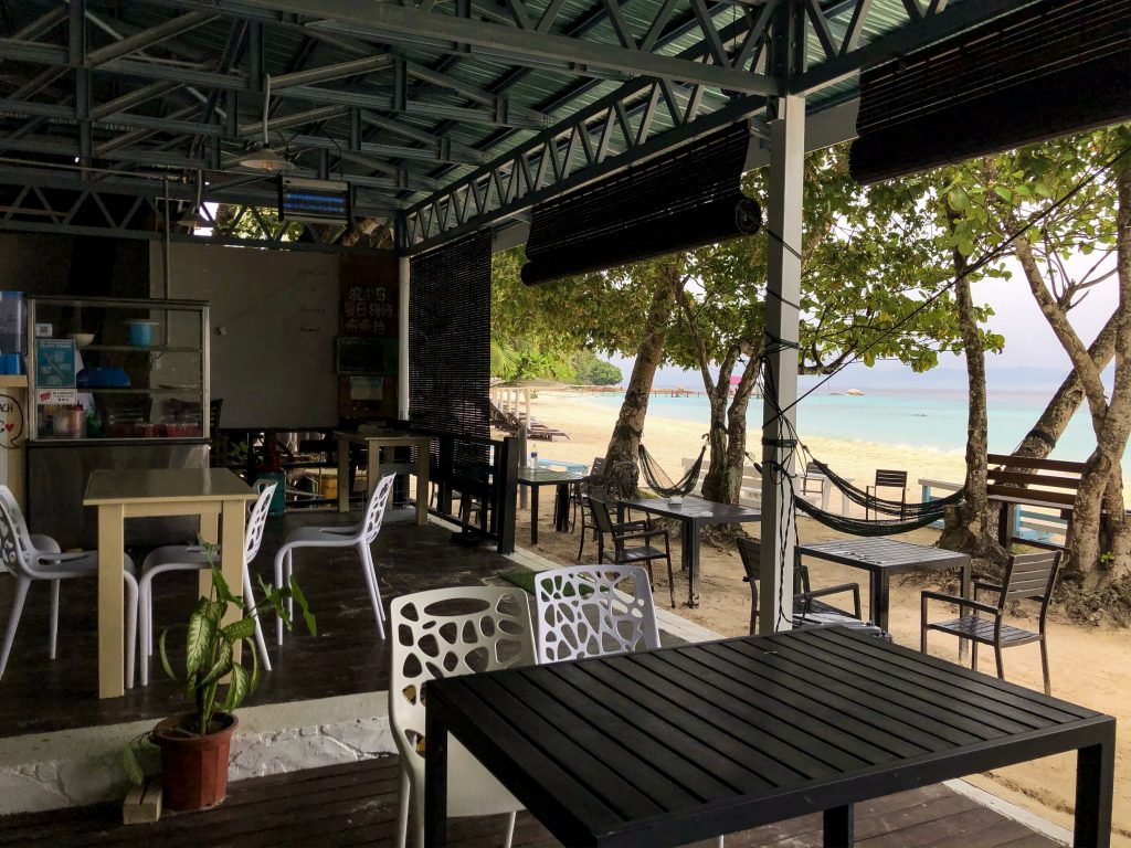 mamak restaurant summer bay lang tengah dining area overlooking beach with hammocks and palm trees 
