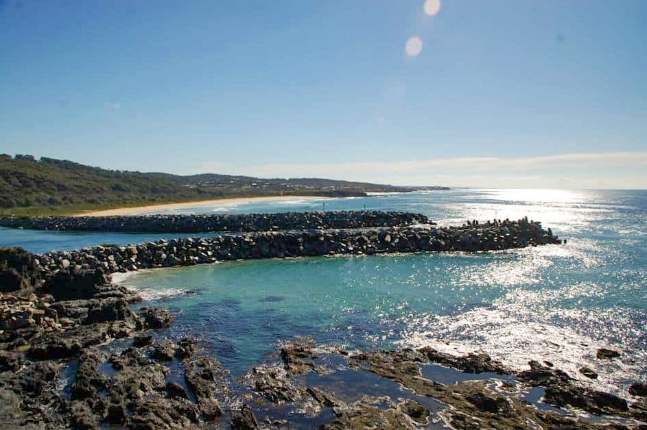 crystal blue sea with black rocks along the coastline of Narooma