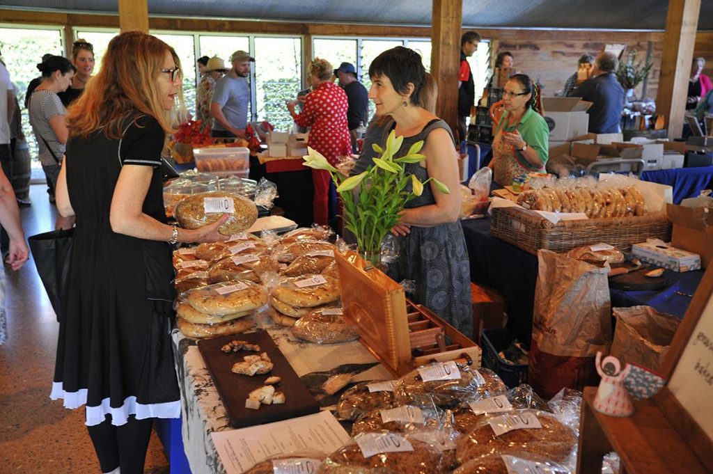lady buying artisanal products inside the barn at Yarra Valley Farmers Market 