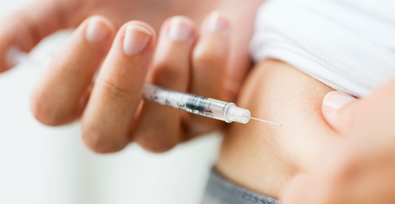 self injection of hcg syringe into side of abdomen area