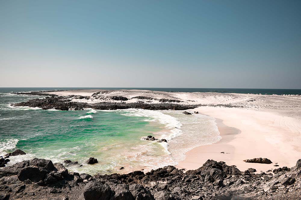 masirah beach in oman with emerald sea water and white sand as one of the best secluded beaches around the world
