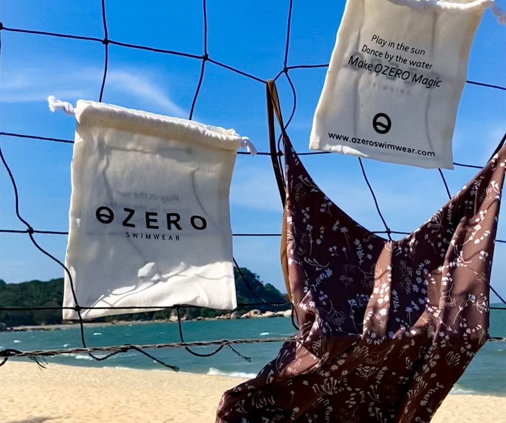 luxury swimwear hanging on a net on the beach