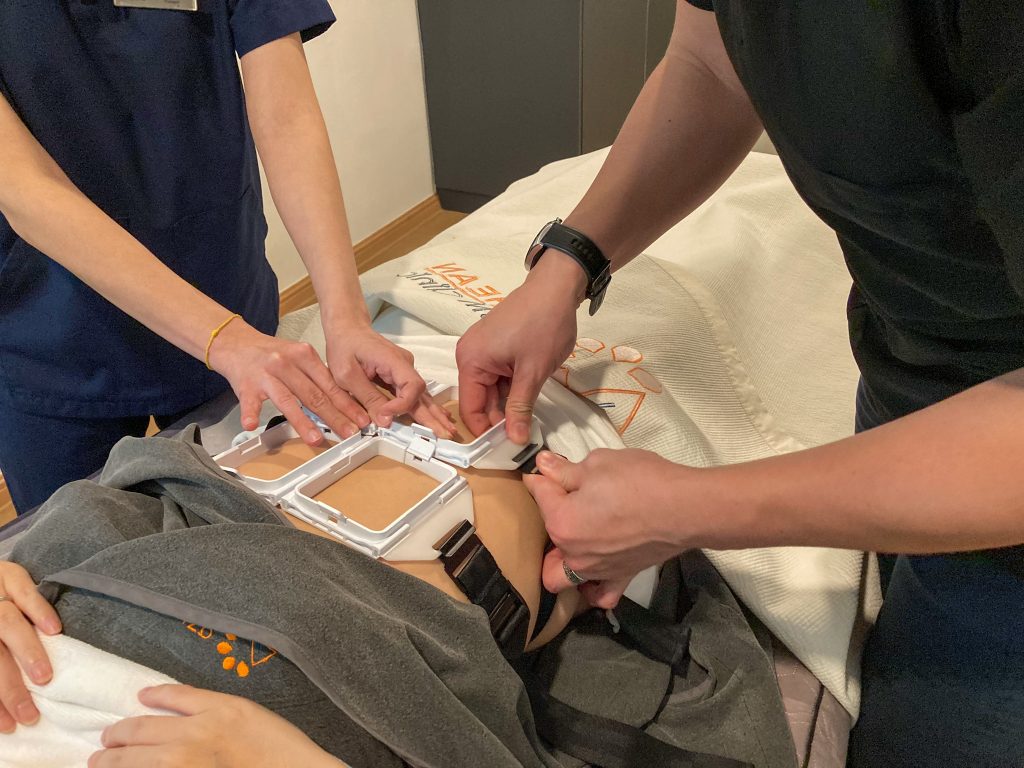 body shaping slimming treatment with le shape placing brackets on tummy area