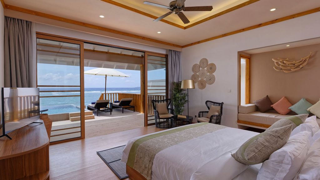 interior bedroom of pool villa overlooking lagoon maldives brennia luxury hotels and resorts in maldives