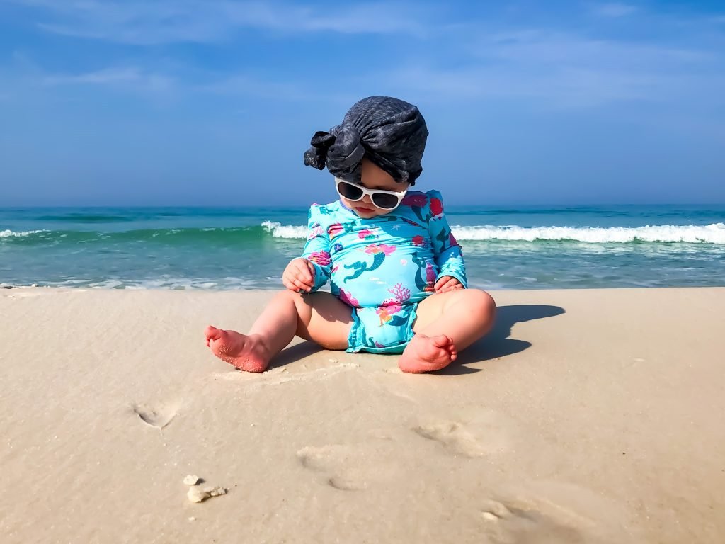 best baby sunscreen sun cream baby on beach with hat