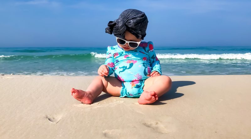 best baby sunscreen sun cream baby on beach with hat
