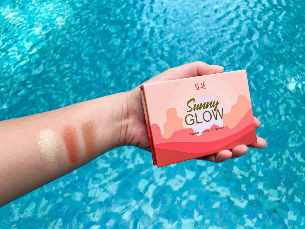 blusher, contour and highlighter swatch on hand by the pool