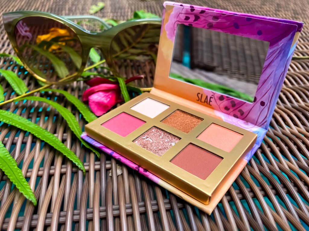 makeup palette kit with sunglasses on rattan chair